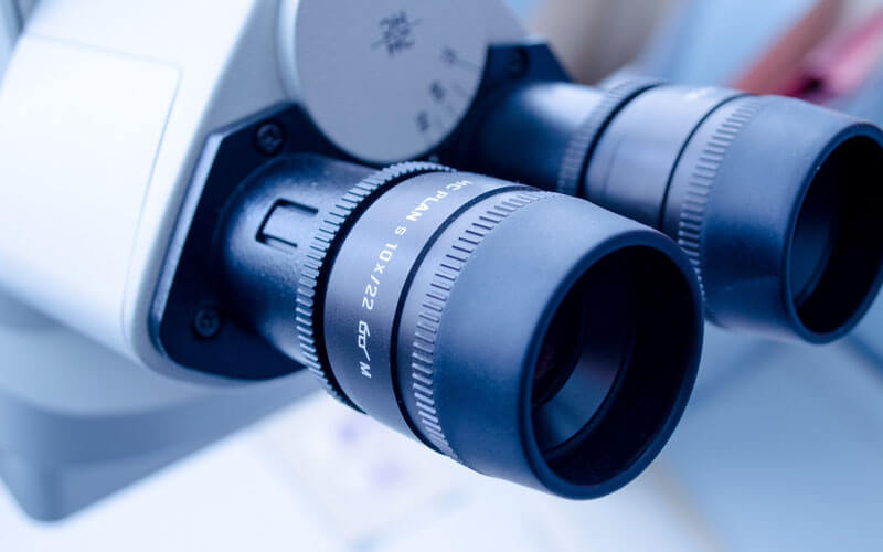 AN image of a microscope that highlights the top of the line technology provided by Correct Vision of Boca Raton. 