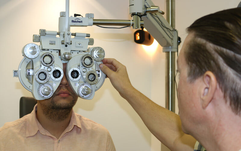 An image of our Boca Raton eye doctor conducting a comprehensive eye exam for South Florida Vision Care. 